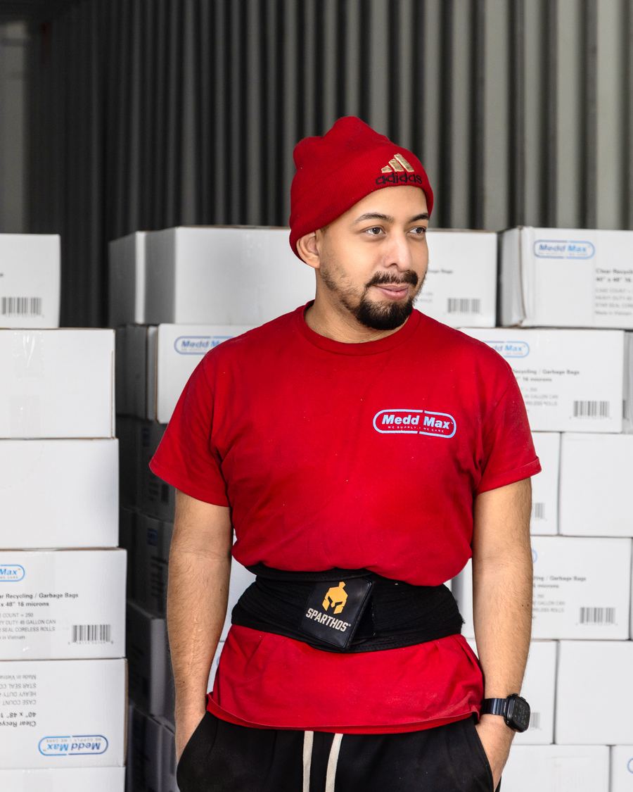 Medd Max warehouse team member in front of a loaded container