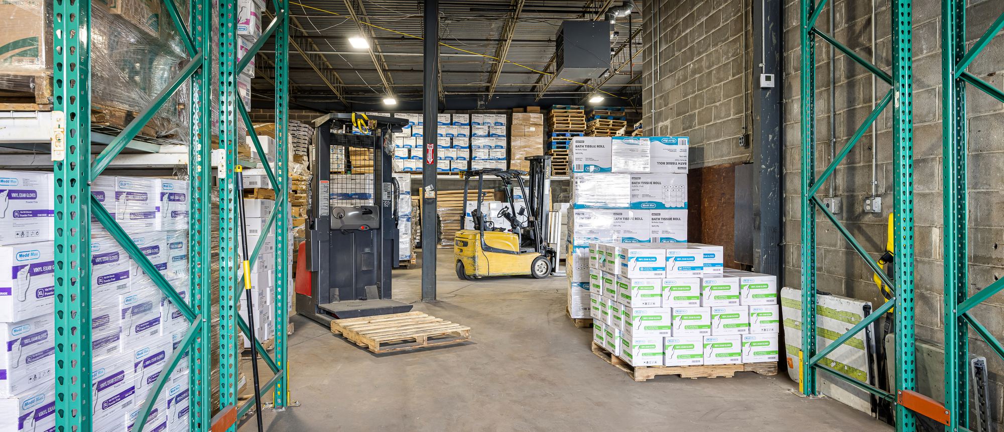 Aisles of palletized medical supplies in the Medd Max warehouse