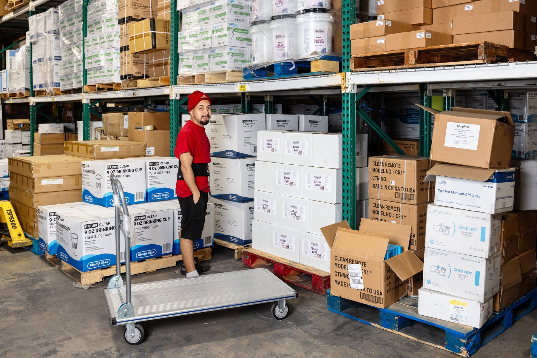 Medd Max team member restocking supplies in the warehouse